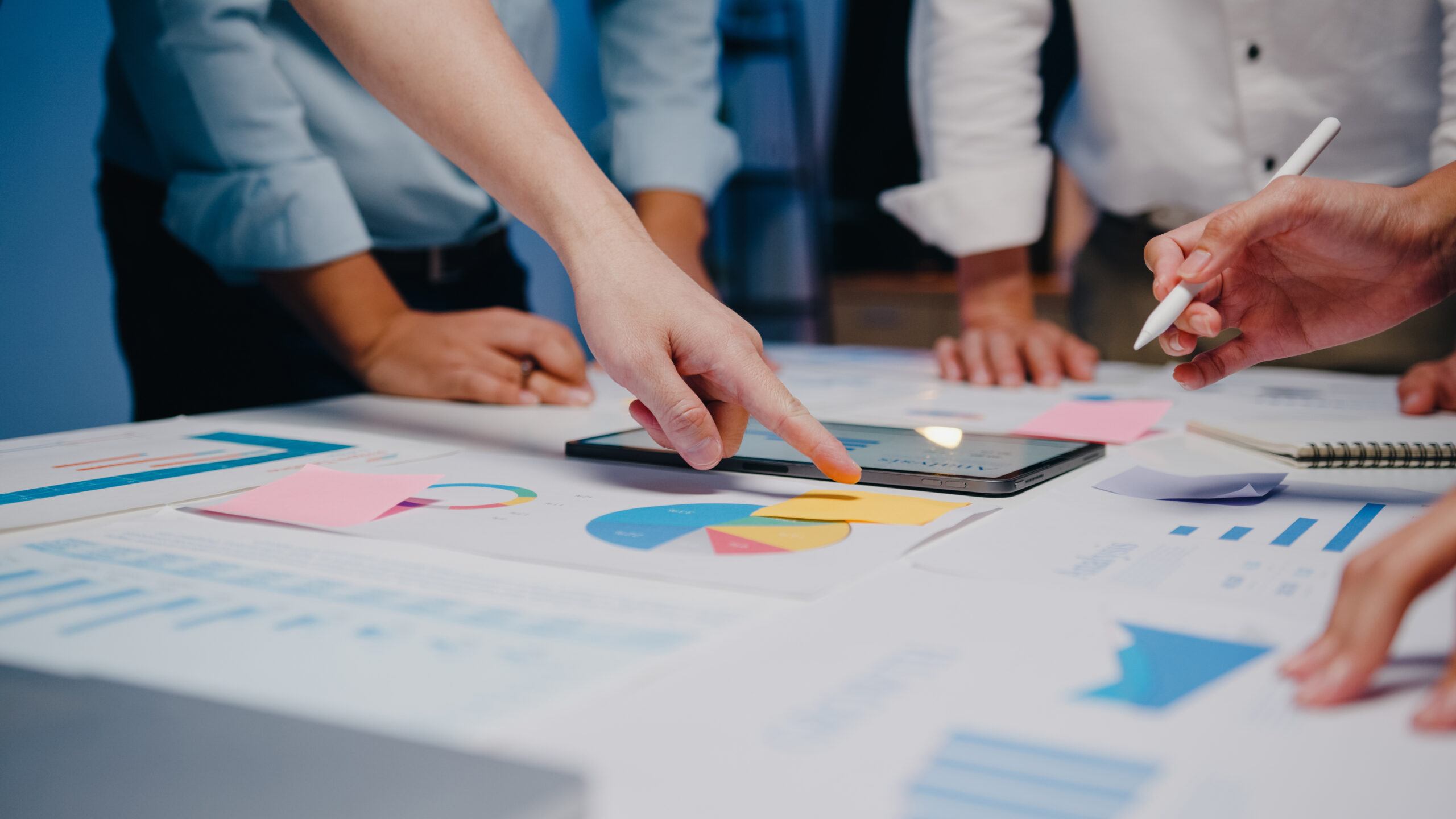 Data-Driven Insights for Smarter Apparel Cost Control Apparel production team analyzing garment cost dashboards with charts on SKU profit margins, fabric performance, and compliance issuesโillustrating how data improves cost control in apparel production through strategic planning.