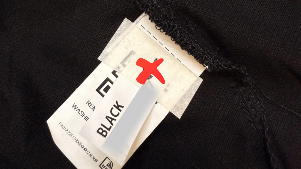 Clothing label with incorrect information highlighted during quality inspection.