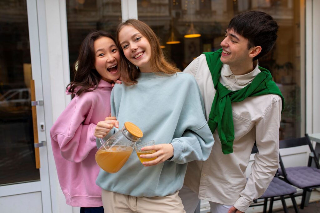 Gen Z and Gen Alpha friends wearing soft lifestyle apparel in a casual social setting, representing community-led fashion discovery and youth-driven fashion spending trends.